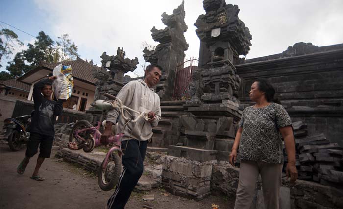 Warga membawa barang-barangnya untuk mengungsi dari Desa Sebudi yaitu salah satu desa terdekat dengan puncak Gunung Agung, Karangasem, Bali, Rabu (20/9). Sebagian warga setempat memilih mengungsi sendiri tanpa harus dievakuasi petugas menyusul adanya rekomendasi zona larangan aktivitas di radius enam hingga 7,5 km dari puncak Gunung Agung yang hingga kini berstatus siaga. (foto: nyoman budhiana/antara)foc/17. 