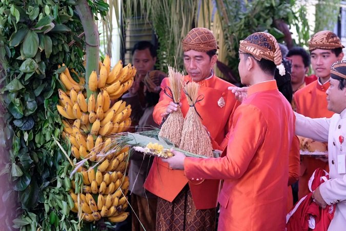 Pemasangan bleketepe oleh, ayahanda Kahiyang, Jokowi. (Foto: Okezone)