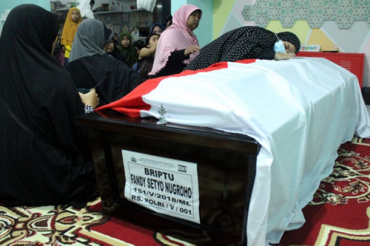 Anggota keluarga berdoa di samping peti jenazah korban kerusuhan di Rutan Mako Brimob almarhum Briptu Fandy Setyo Nugroho di rumah duka, di Kompleks Polri, Jatirangga, Bekasi, Jawa Barat, Rabu 9 Mei 2018. Almarhum Briptu Fandy Setyo Nugroho menjadi salah satu korban meninggal akibat insiden kerusuhan di Rutan Mako Brimob, Depok. (Foto: Antara)