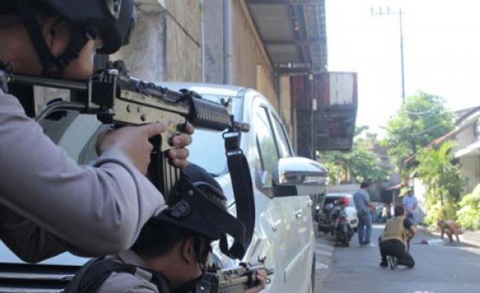 Polisi menghentikan dan memeriksa warga yang melintas di Jalan Niaga Samping setelah terjadi ledakan di Polrestabes Surabaya, Jawa Timur, Senin 14 Mei 2018. (foto: didik suhartono/antara)