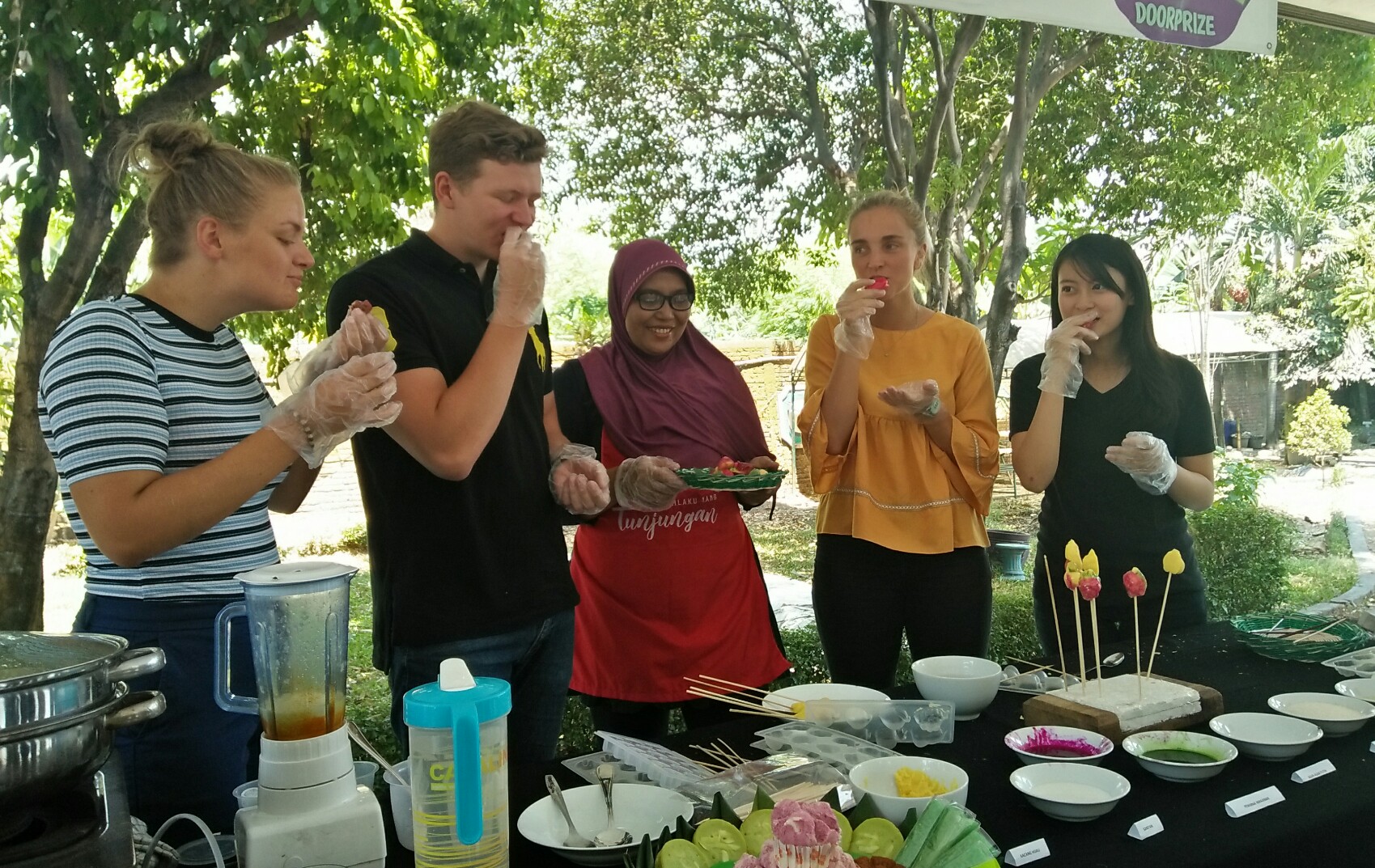 Christin, Ingvar, dan Anneke mencoba kue cikak hasil buatannya. (Foto: Amanah/ngopibareng.id)