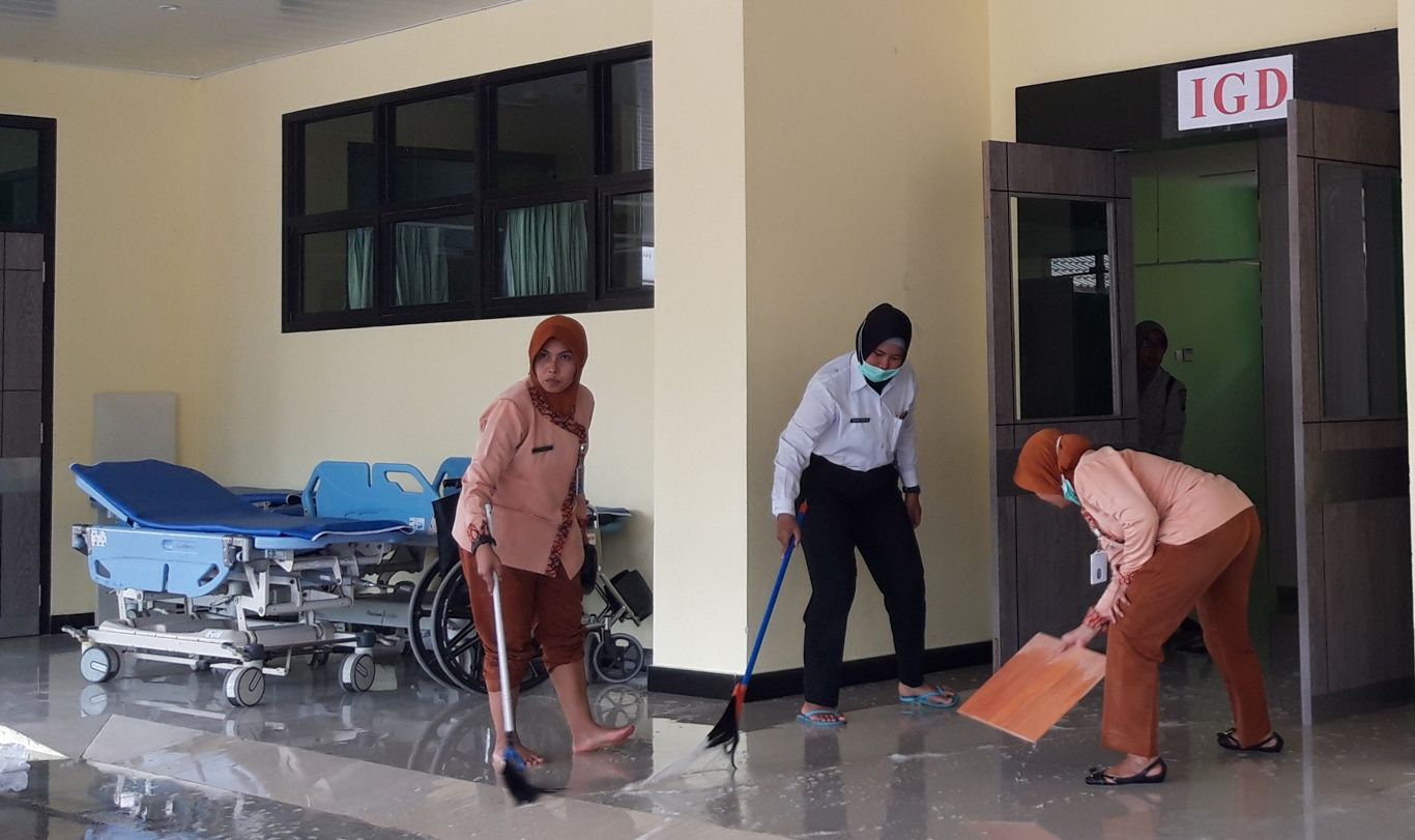 Perugas RS Bhayangkara membersihkan sisa air bekas memadamkam api. (foto: Haris/ngopibareng)