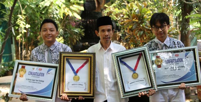 Dua siswa MAN 1 Pasuruan didampingi Kepala Sekolah MAN 1 menunjukkan medali emas ajang Robofest Japan 2019. (Foto: Dok Humas)