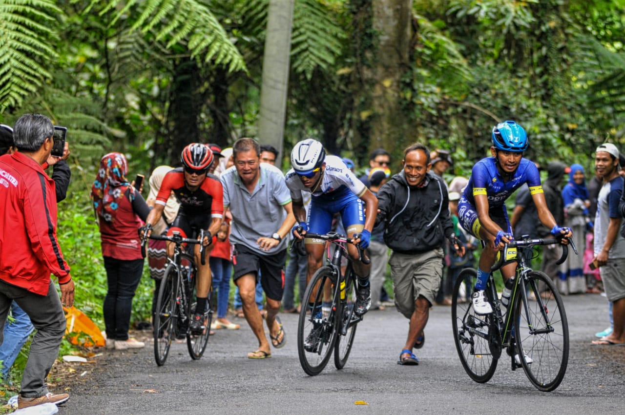 Penonton berusaha membantu pembalap saat berada ditanjakan erek-erek gunung Ijen. Sabtu (28/9). Lokasi erek-erek ini dikenal dengan tanjakan tajamnya yang hampir mencapai kemiringan 45 derajat.