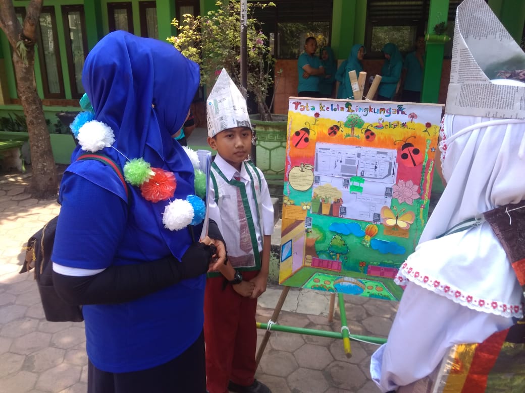 Siswa SDN Klojen Kota Malang saat menjelaskan mind mapping tata kelola banjir di hadapan salah satu juri. (Foto: Theo/ngopibareng.id)