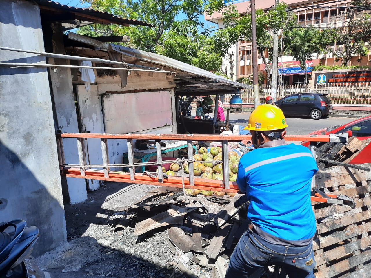 Petugas PLN saat datang dan mengidentifikasi aliran listrik di pasar beras Bendul Merisi. (Foto: Alief/ngopibareng.id)