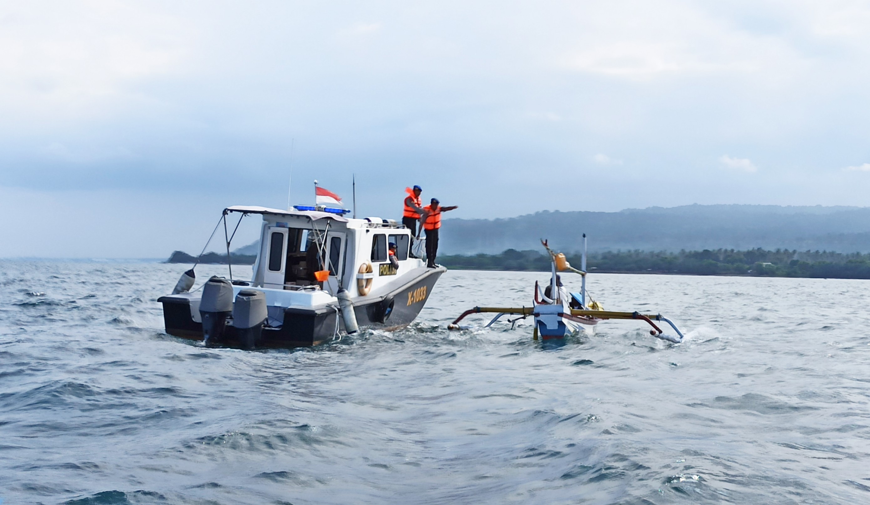 Petugas Polairud Banyuwangi berkoordinasi dengan nelayan yang sedang mencari ikan di sekitar Pulau Tabuhan (foto : Hujaini/ngopibareng.id)