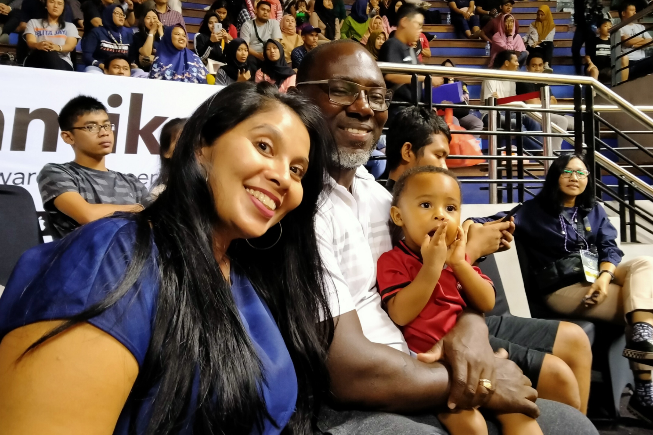 Pelatih Persipura, Jackson F Tiago bersama istri dan anaknya saat menyaksikan laga IBL 2020 di DBL Arena, Surabaya, Minggu 8 Maret 2020. (Foto: Fariz Yarbo/Ngopibareng.id)