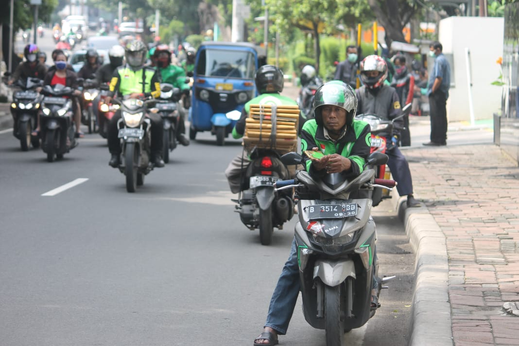 Driver Ojol menjerit akibat sepinya penumpang akibat pembatasan keluar rumah.dan sekolan diliburkan.( foto: Asmanu Sudharso/Ngopibareng.id)