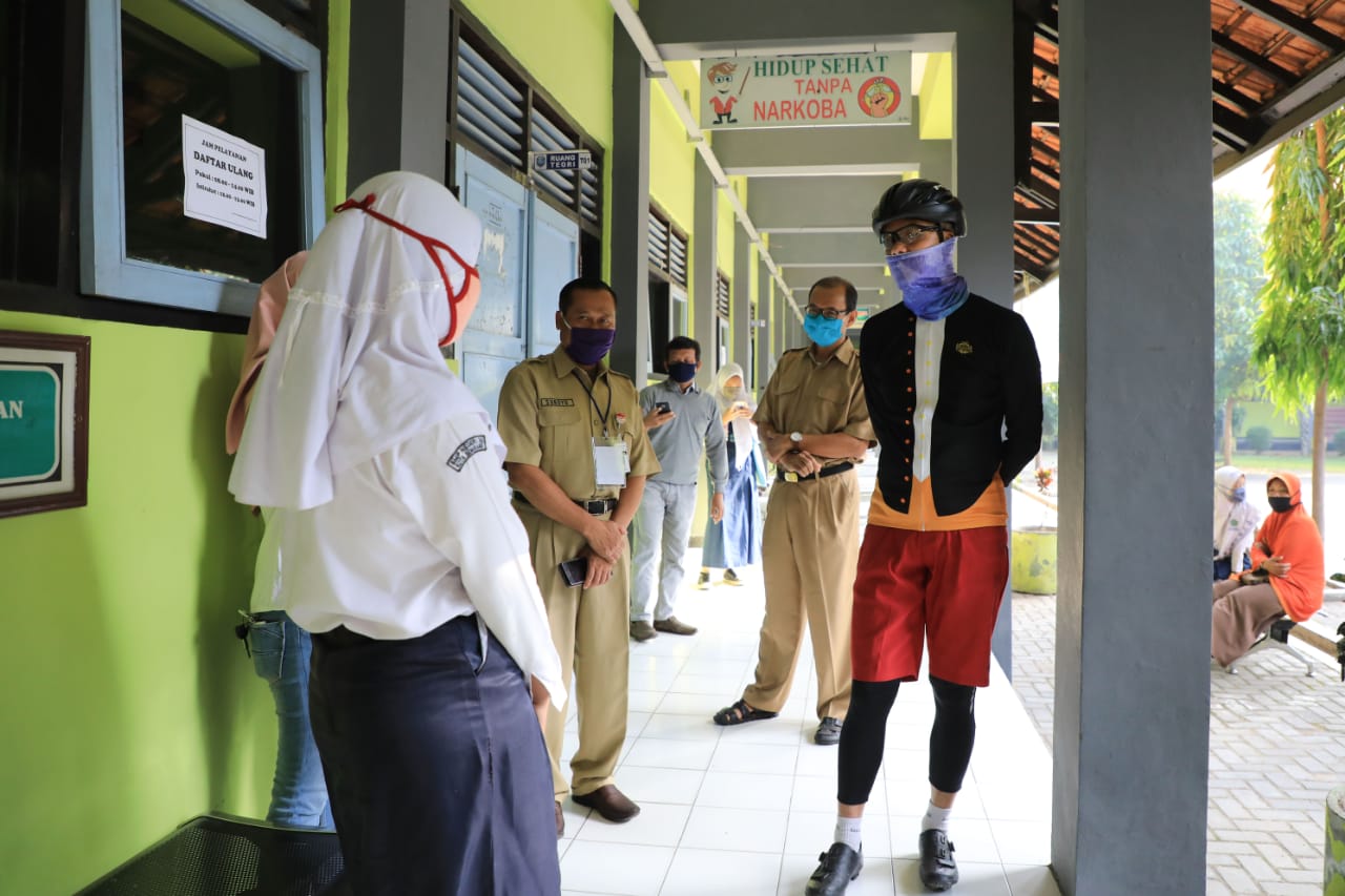 Disela gowes paginya, Gubernur Ganjar mengecek proses verifikasi berkas pendaftaran di SMKN 1 dan SMKN 5 Semarang, Senin, 6 Juli 2020. (Foto: Ist/Ngopibareng.id)