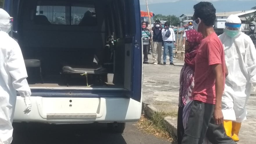 Perempuan positif Covid-19 asal Giliketapang tiba di pelabuhan dijemput mobil ambulans. (Foto: Ikhsan Mahmudi/Ngopibareng.id)