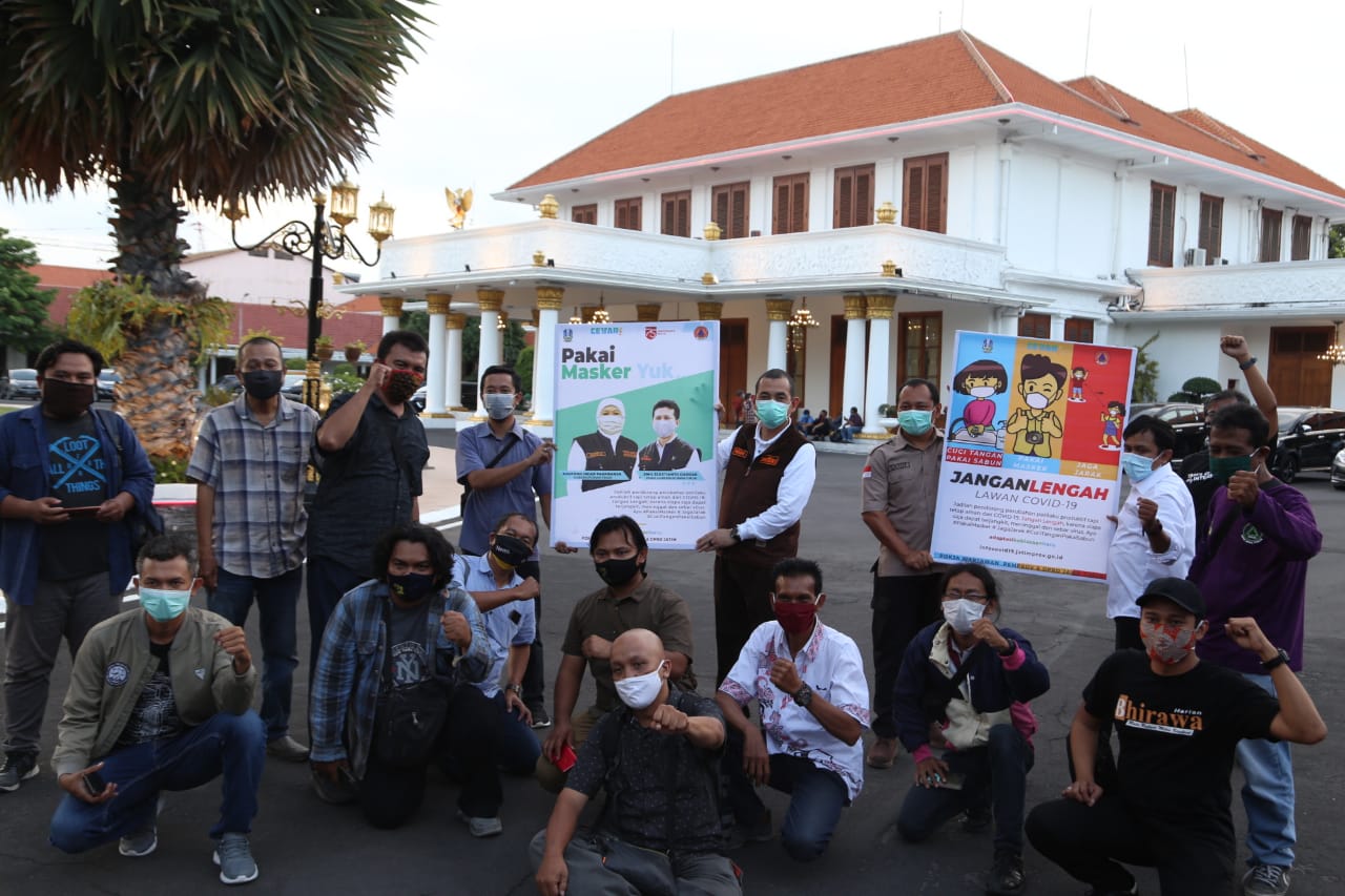 Kalaksa BPBD Jatim, Yanuar Rachmadi (tengah) bersama wartawan menyosialisasikan protokol kesehatan di depan halaman Gedung Negara Grahadi, Surabaya, Selasa 22 September 2020. (Foto: Istimewa) 