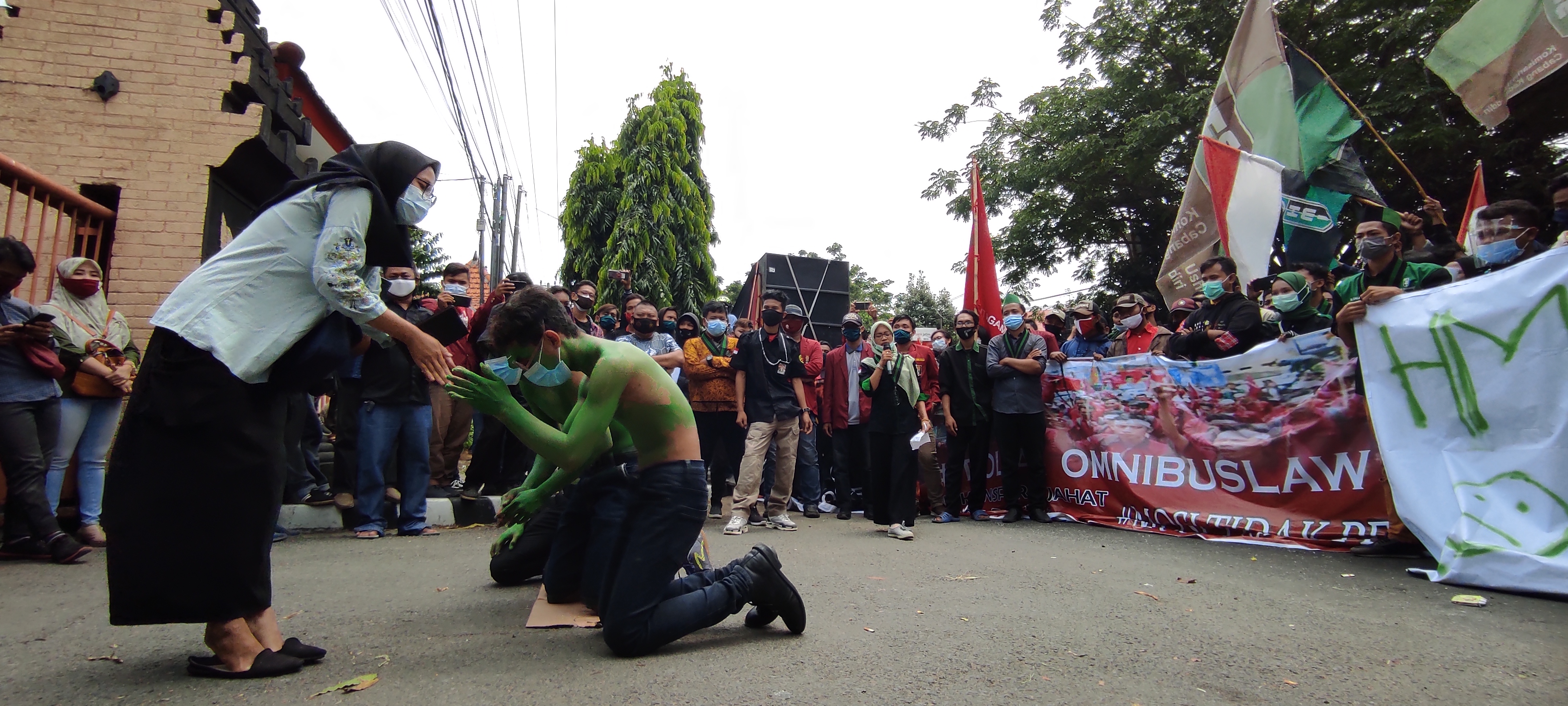 Aksi tolak ominibuslaw diwarnai aksi teatrikal. (Foto: Fendhy Plesmana/Ngopibareng.id)