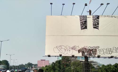 Agustinus yang punya hobi memanjat fasilitas umum, hari ini, Senin, kembali membuat jalanan di Jl. Jenderal Sudirman Jakarta macet. (Foto:Antara)