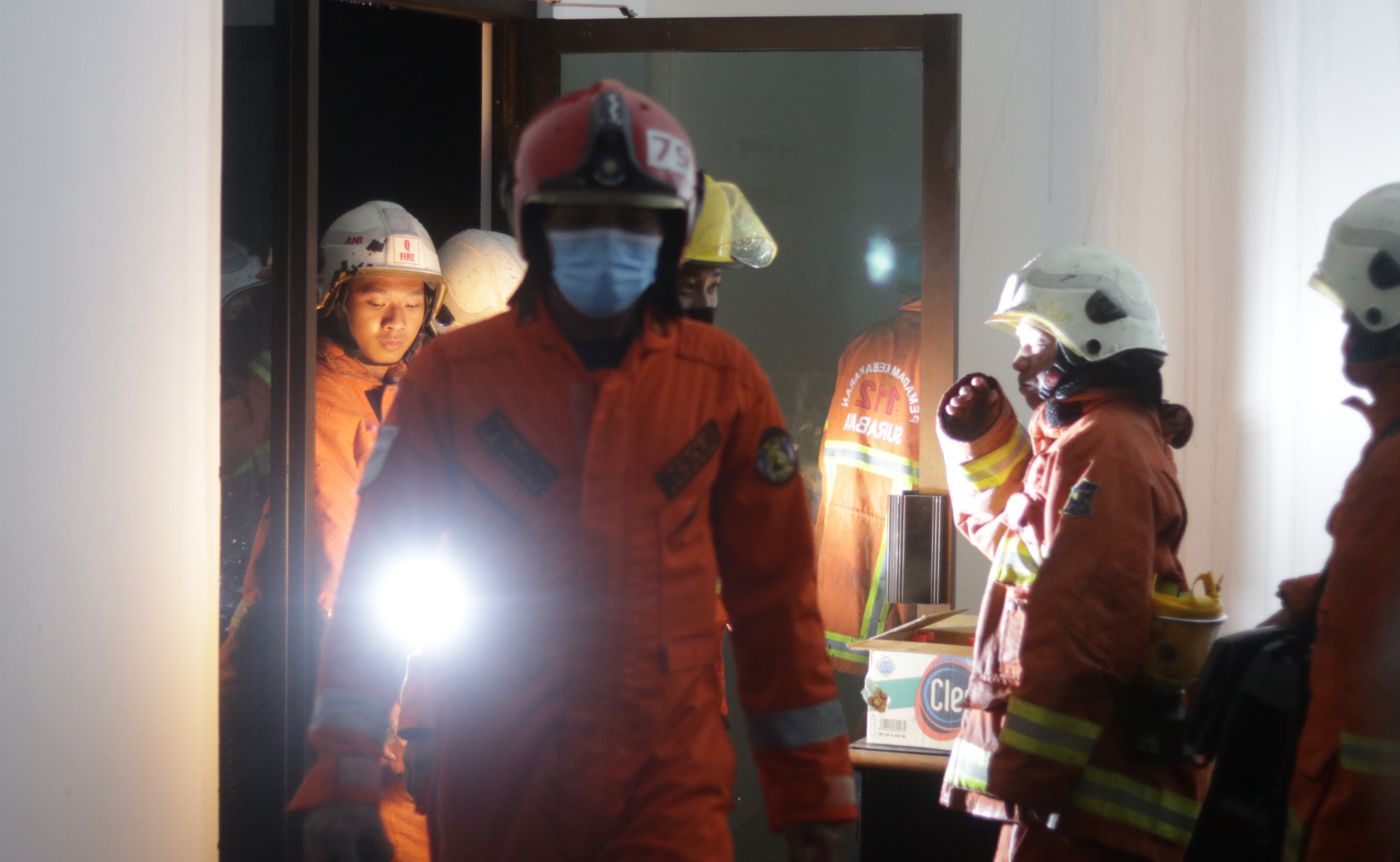 Petugas PMK Kota Surabaya ketika melakukan evakuasi terhadap rumah kosong yang terbakar di Jalan Raya Kendangsari, Surabaya, Kamis 12 November 2020 malam. (Foto: Fariz Yarbo/Ngopibareng.id)