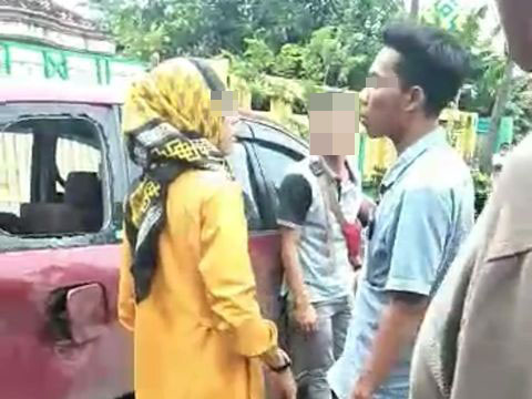 Oknum kepala desa (Kades) tampak bersandar di mobil saat ia dan teman wanitanya dihadang massa di tengah jalan. (Foto: Istimewa)