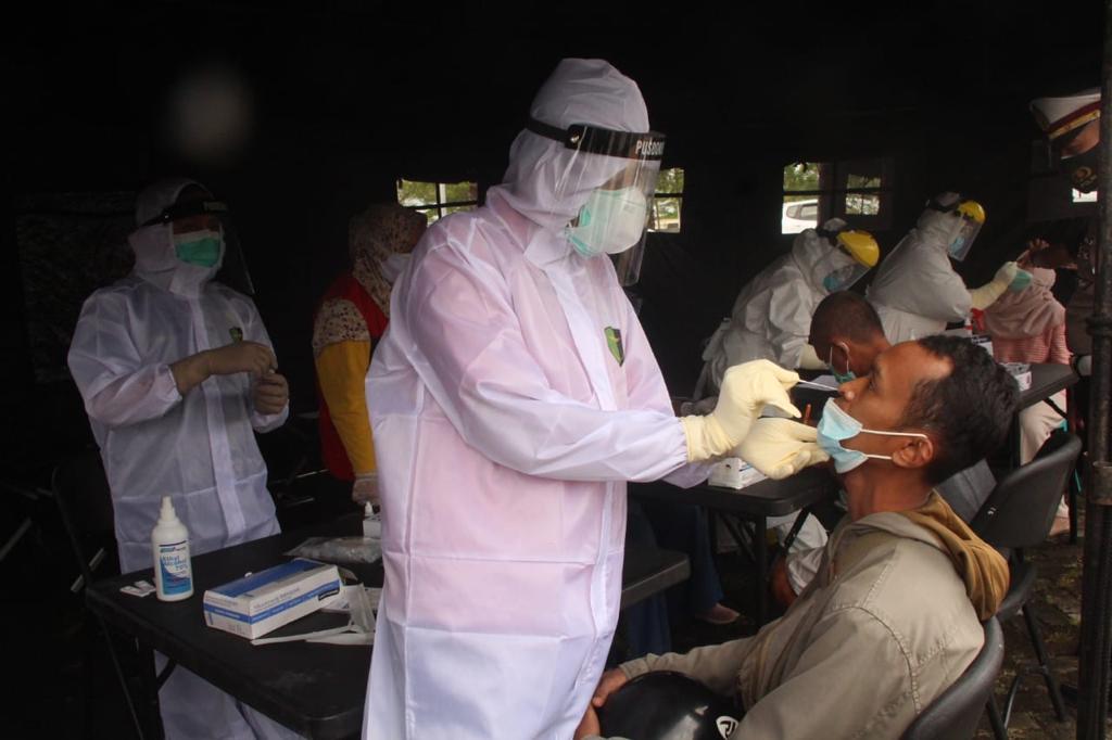 Salah satu pengguna jalan yang melintas di depan Kantor Kabupaten Blitar sedang menjalani swab. (Foto: Choirul Anam/Ngopibareng.id)