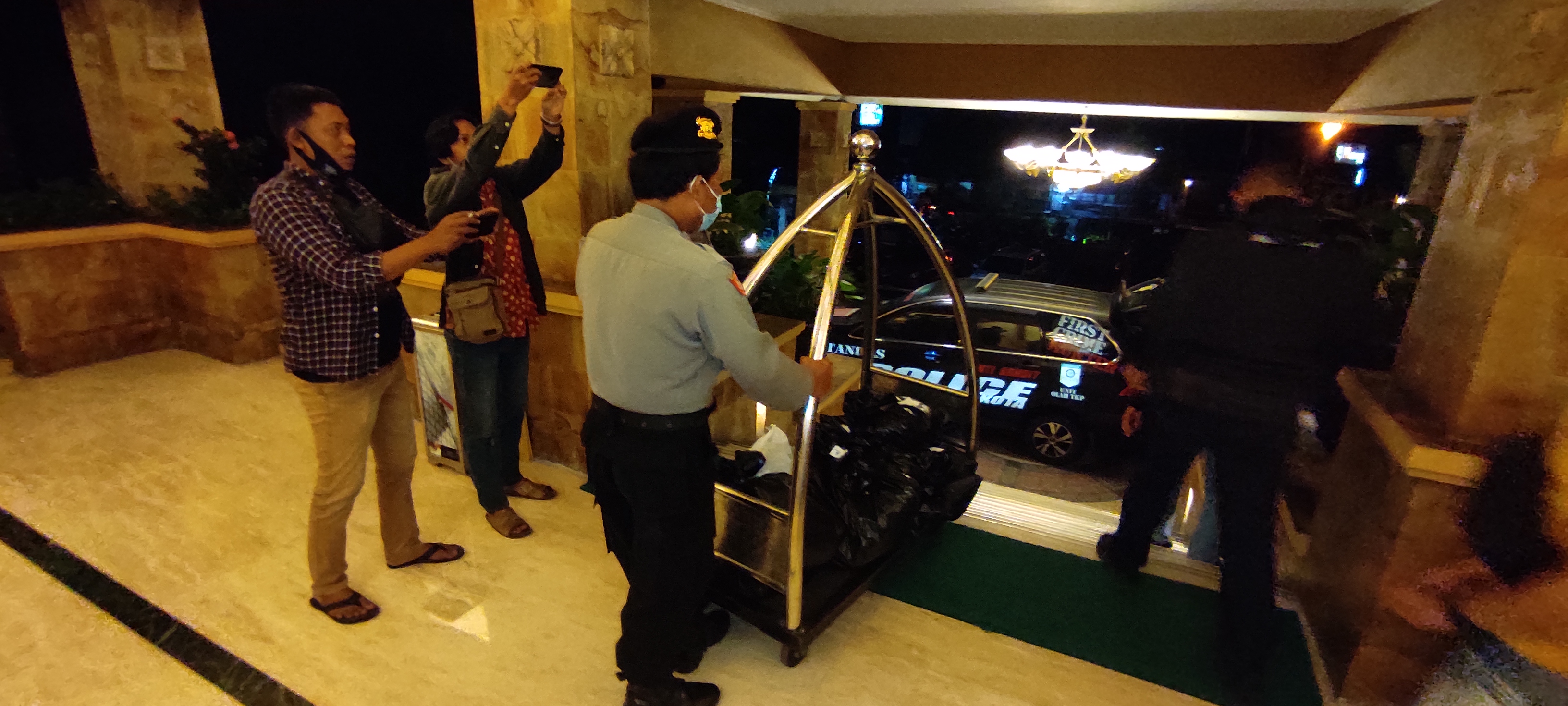 Polisi amankan barang bukti dari kamar hotel. (Foto: Fendhy/ngopibareng.id) 