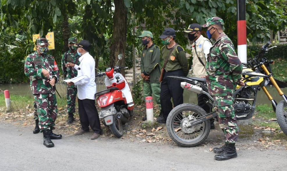 Komandan Kodim 0825 Banyuwangi Letkol Infanteri Yuli Eko Purwanto berkoordinasi dengan Kades Ringintelu Budi Santoso saat berkunjung ke Dusun Yudomulyo untuk melihat langsung penanganan klaster tarawih (Foto:istimewa)