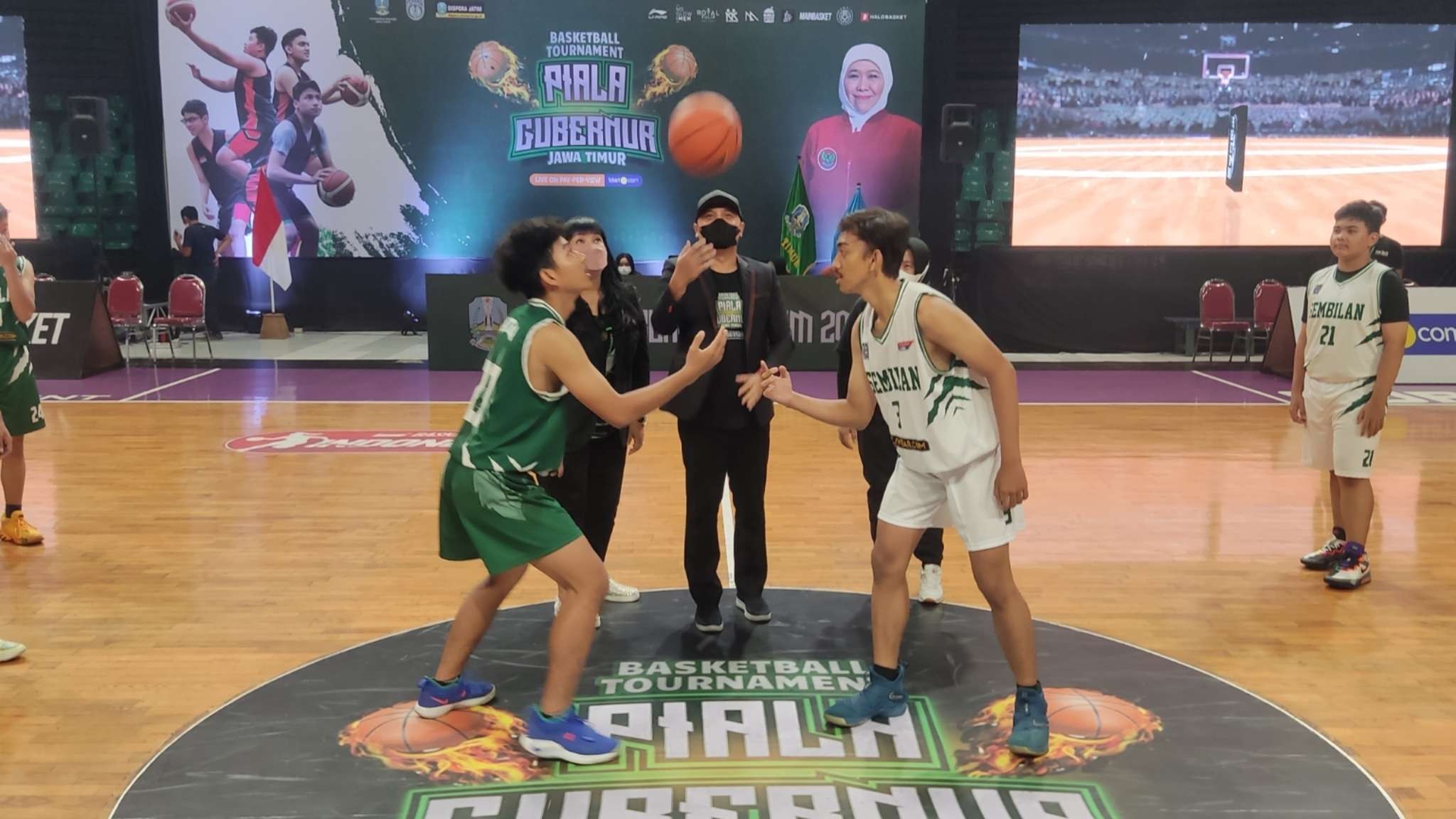 Kadispora Jatim, Pulung Chausar melakukan tip off tanda dibukanya Kejuaraan Basket Antar SMA se-Indonesia di GOR Kertajaya, Surabaya, Kamis 16 Desember 2021. (Foto: Fariz Yarbo/Ngopibareng.id)