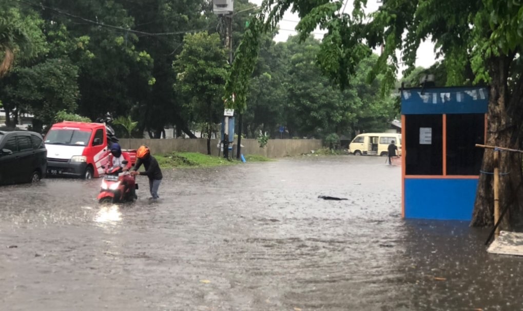 Tampak satu sepeda motor yang nekat menerjang banjir di Jalan Kidal (Foto: Andhi Dwi/Ngopibareng.id)