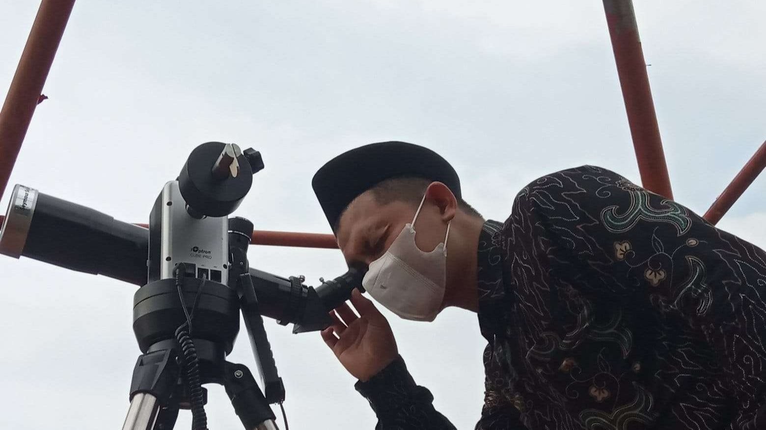 Petugas dari Kantor Depag Bojonegoro dengan menggunakan alat teropong melihat bulan di Menara Museum Geopark, di bawah Dinas Kebudayaan dan Pariwisata Bojonegoro.(Foto: Sujatmiko/Ngopibareng.id)     Bukit Wonocolo, Museum Geopark dan Menara Melihat Hilal