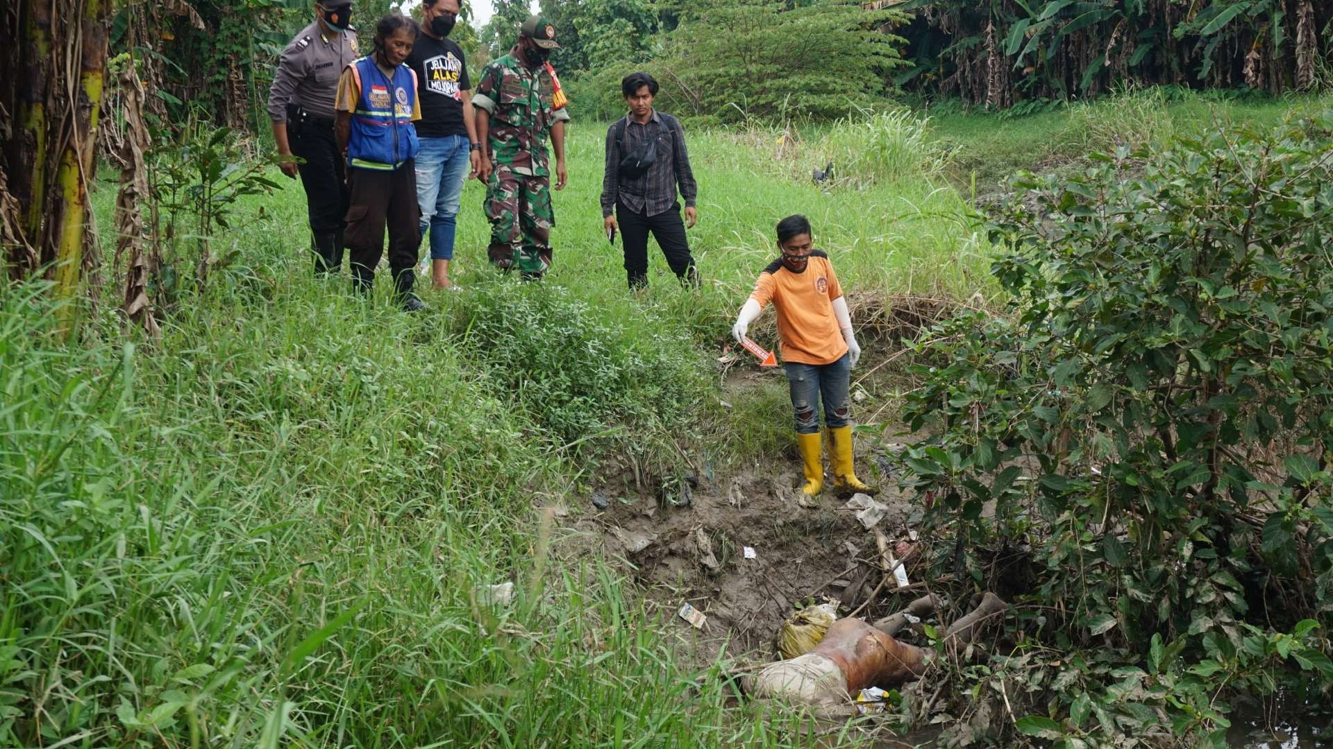 Petugas melakukan olah TKP di tempat penemuan mayat.(Deni Lukmantara/Ngopibareng)