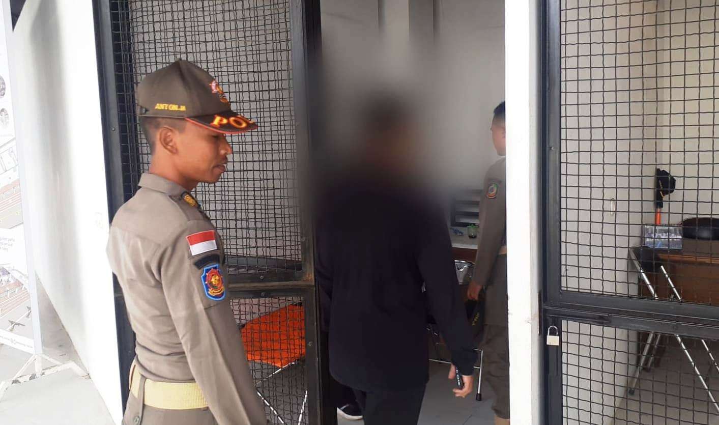 Petugas mengamankan sejoli yang kedapatan bermesraan di Terminal Pariwisata Terpadu (foto:istimewa)