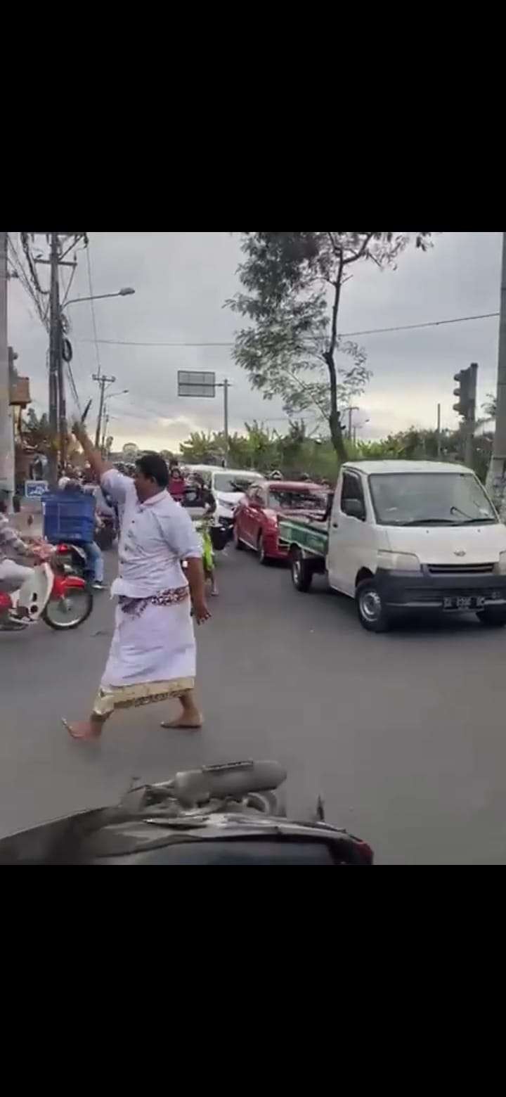 Seorang pria yang diduga Orang Dengan Gangguan Jiwa (ODGJ) mengamuk di jalanan sambil mengayunkan senjata tajam ke pengendara yang melintas.(Foto: Tangkapan layar Instagram)