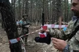 Oleg Kotenko, komisaris Ukraina untuk Masalah Orang Hilang dalam Keadaan Khusus (kiri) memeriksa kuburan massal di Izium yang baru-baru ini direbut kembali dari pasukan Rusia. (Foto:AP)