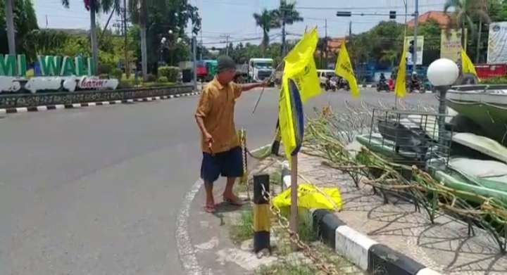 Proses pencopotan bendera partai yang dipasang di bundaran Patung Letda Sutcipto Tuban (Foto: Tangkapan Layar Video)