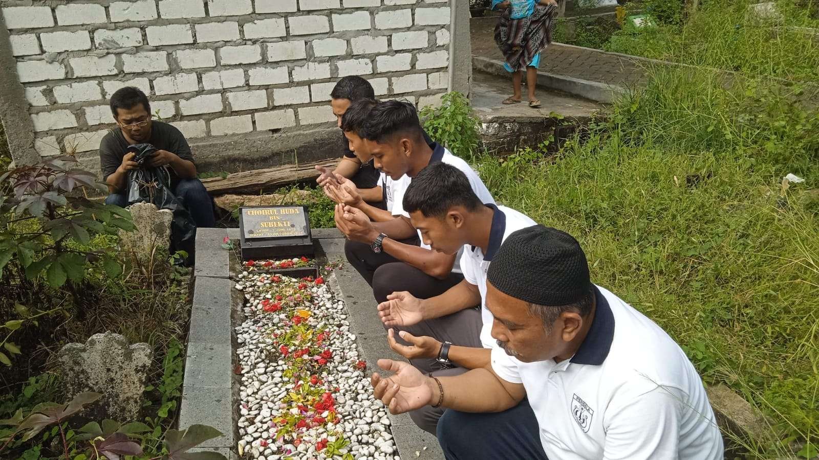 Keterangan Foto :   Manajer Persela. Fariz Julinar dan beberapa pemain sat berziarah di makam penjaga gawang legendaris Choirul Huda. (Foto ; Imron Rosidi/ngopibareng.id)