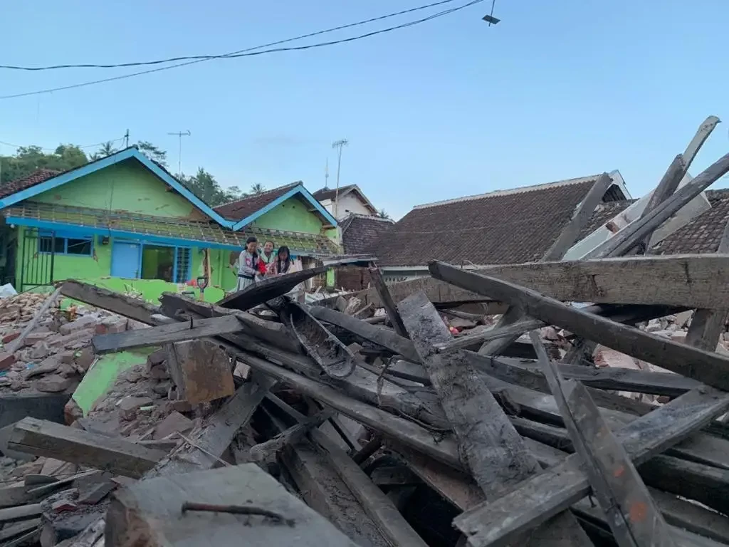 Sejumlah anak kecil bermain di sisa-sisa reruntuhan puing bangunan yang runtuh akibat gempa bumi di Kecamatan Dampit, Kabupaten Malang (Foto: Lalu Theo/Ngopibareng.id)