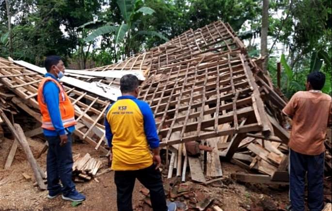 Anggota BPBD meninjau rumah warga rusak dihajar hujan angin.(foto: BPBD Situbondo)