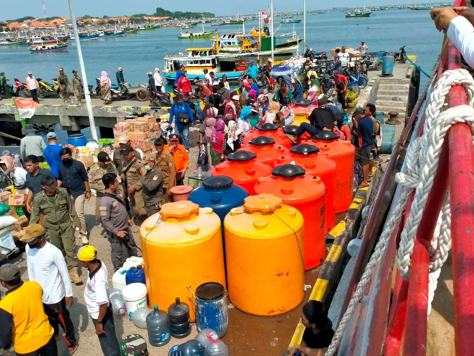 Warga di Pulau Giliketapang, Kecamatan Sumberasih, Kabupaten Probolinggo saat dipasok air bersih. (Foto: Ikhsan Mahmudi/Ngopibareng.id)