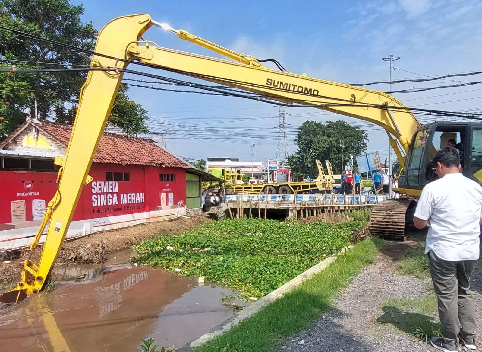 Petugas dengan ekskavator membersihkan badan sungai di kawasan Bundaran Gladser, Kota Probolinggo. (Foto: Ikhsan Mahmudi/Ngopibareng.id)