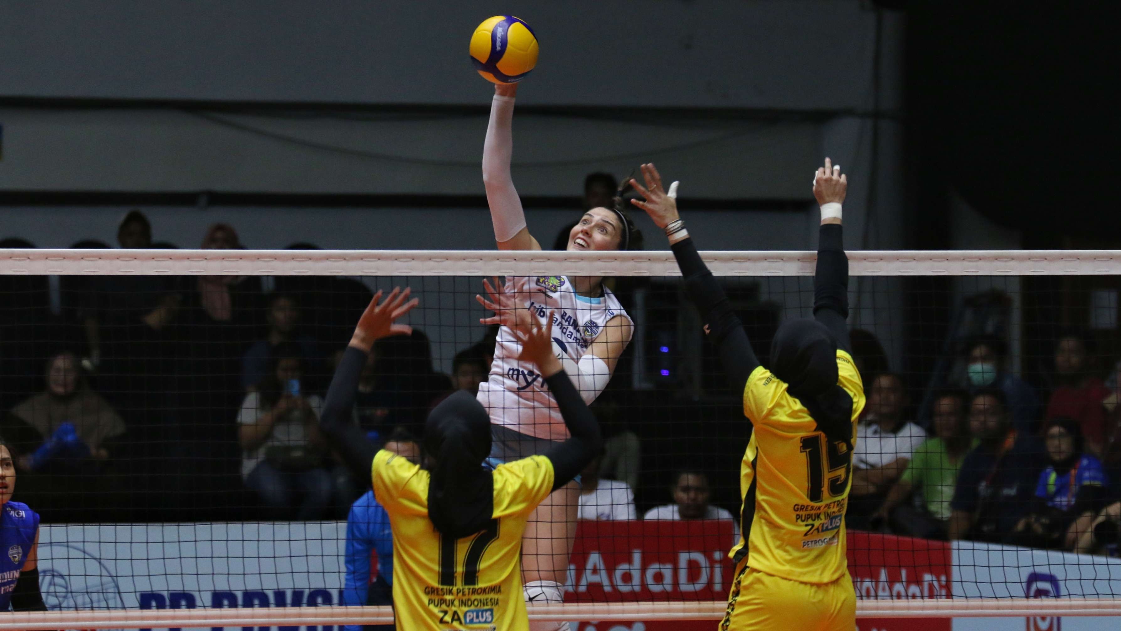 Pemain BJB Tandamata, Ceren Kapucu (putih) melakukan spike ke arah Gresik Petrokimia Pupuk dalam laga final four Proliga 2023 di GOR Tridarma, Gresik, Sabtu 25 Februari 2023. (Foto: Fariz Yarbo/Ngopibareng.id)