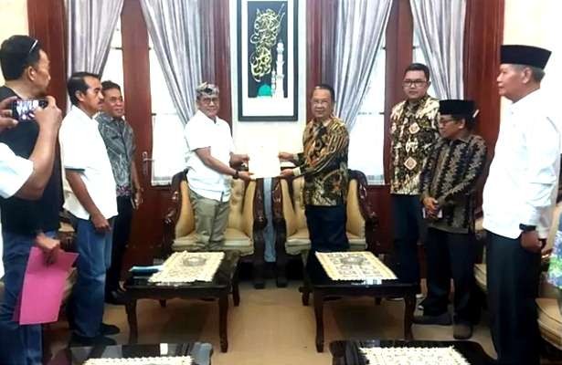 Ketua DPRD Bondowoso, Ahmad Dhafir (kanan) saat menyerahkan surat resmi yang diterima Sekda Bambang Sukwanto di Pendapa Rafen Bagus Assra Bondowoso. (Foto: Humas DPRD Bondowoso)