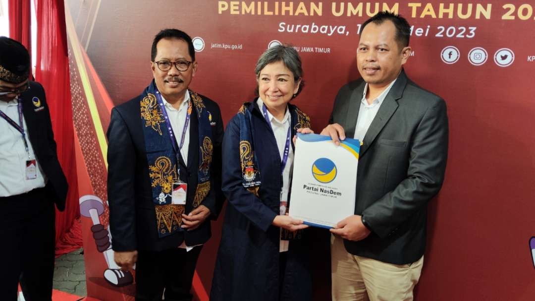 Ketua DPW NasDem Jatim, Sri Sajekti Sudjunadi (tengah) menyerahkan berkas pendaftaran kepada Ketua KPU Jatim Choirul Anam di Kantor KPU Jatim, Surabaya, Kamis 11 Mei 2023. (Foto: Fariz Yarbo/Ngopibareng.id)