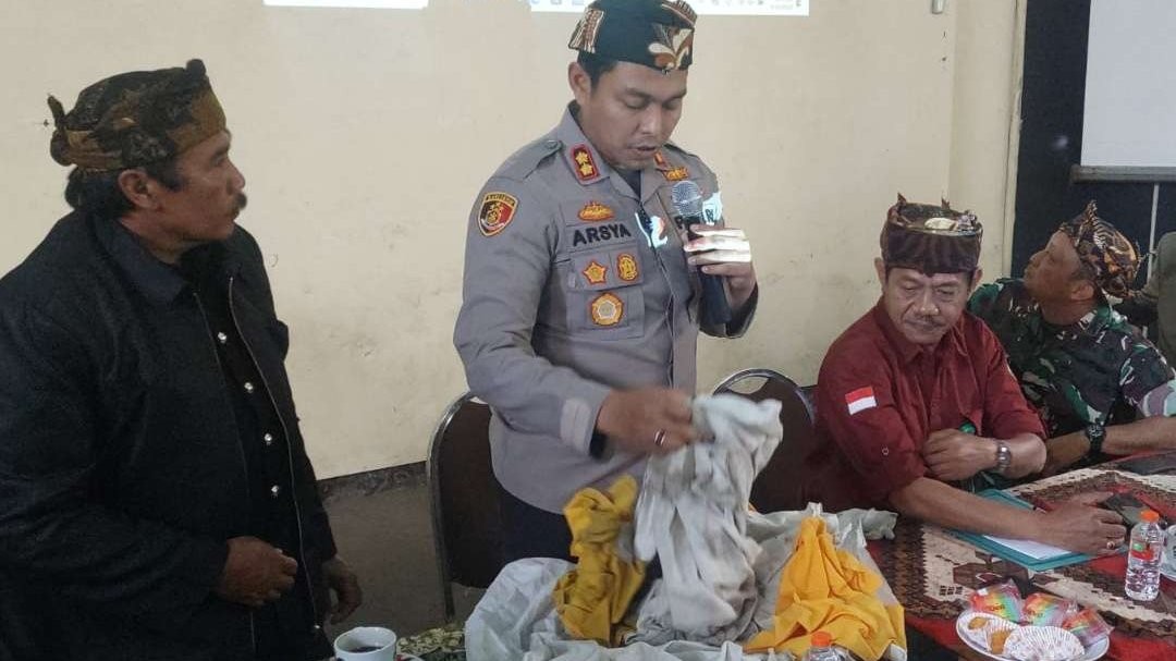 Kapolres Probolinggo, AKBP Teuku Arsya Khadafi menunjukkan kain putih dan kuning yang sebelumnya melekat pada Patung Ganesha. (Foto: Ikhsan Mahmudi/Ngopibareng.id)