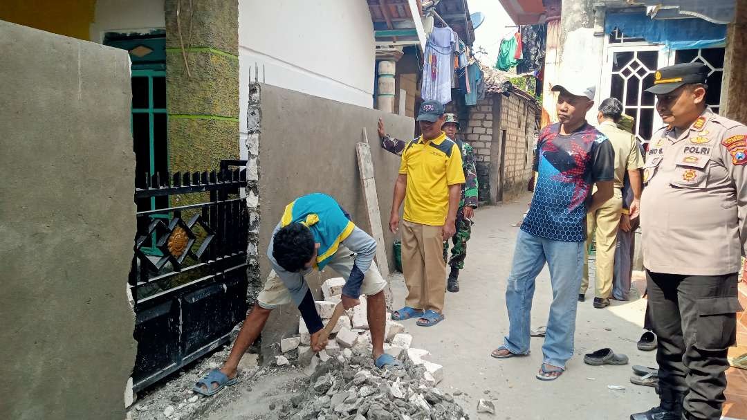 Proses pembongkaran tembok disaksikan oleh Forkopimka Tambakboyo. (Foto: Khoirul Huda/Ngopibareng.id)