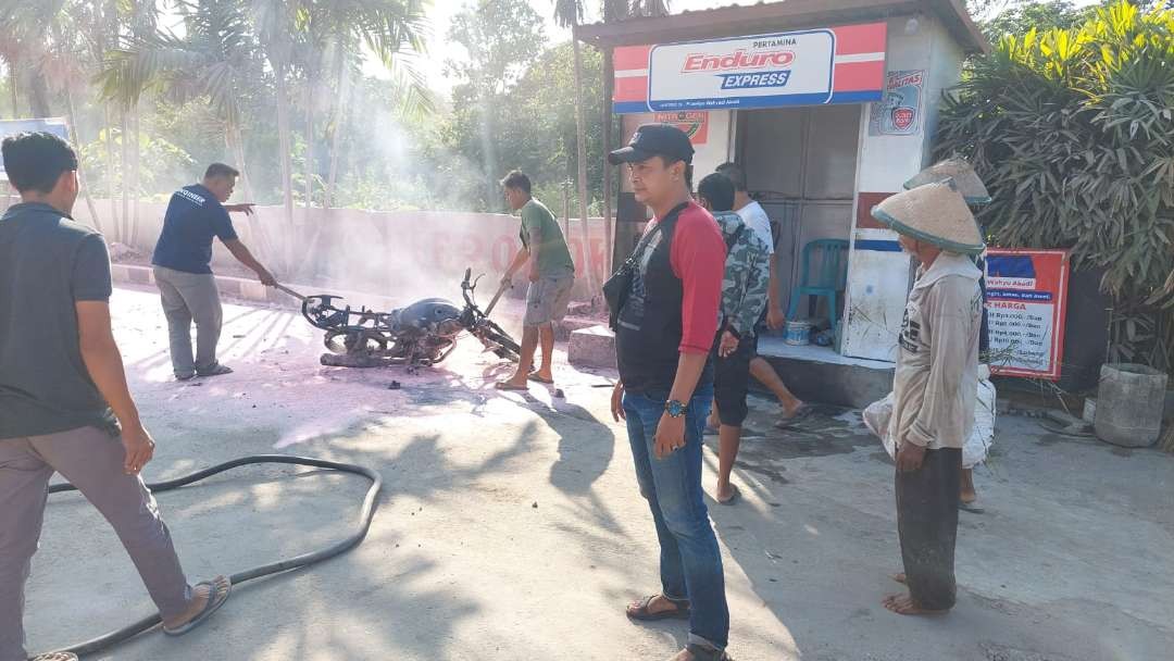 Petugas mendatangi lokasi kejadian motor terbakar saat isi angin nitrogen (dok. Polsek Singgahan)