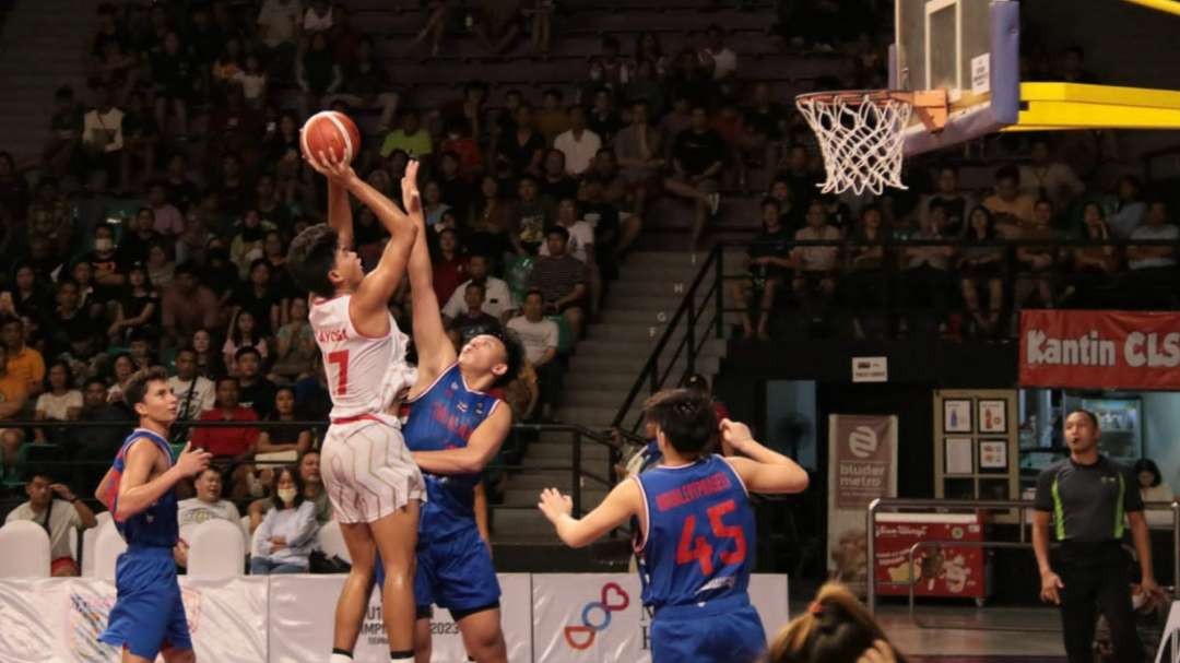 Pemain Timnas Indonesia, I Ketut Gede Bayu Prayoga (putih) mencoba melepaskan tembakan ke arah ring Thailand dalam laga FIBA U-16 Asian Championship 2023 SEABA Qualifiers di GOR Kertajaya, Surabaya, Senin 17 Juli 2023. (Foto: Fariz Yarbo/Ngopibareng.id)