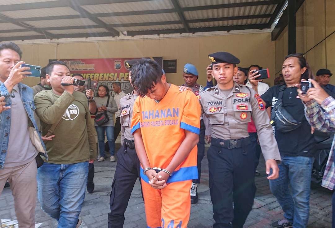 Pelaku RI saat diamankan petugas Polresta Sidoarjo (foto : Aini/Ngopibareng.id)