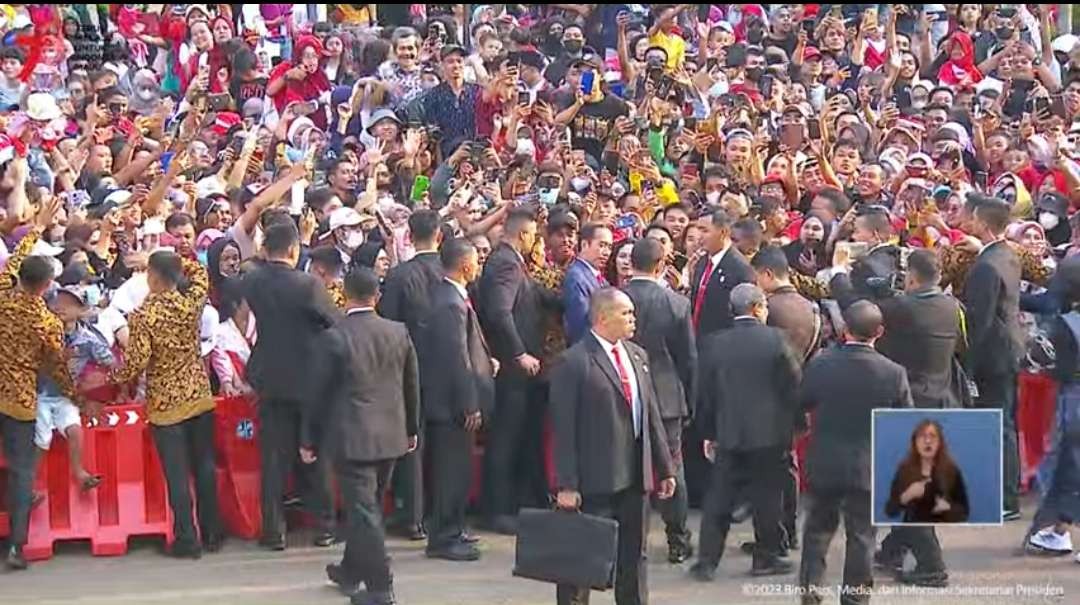 Paspampres sibuk mengamankan Presiden Jokowi yang melayani permintaan selfie para warga yang menyaksikan Upacara Penurunan Bendera Merah Putih di luar halaman Istana Merdeka Jakarta, Kamis 17 Agustus 2023 sore. (Foto: YouTube Setpres)