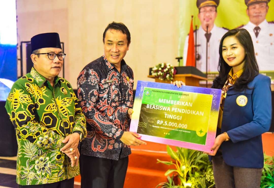 Simbolis penyerahan beasiswa Pemkab Sidoarjo kepada salah satu mahasiswa (foto : Aini/Ngopibareng.id)