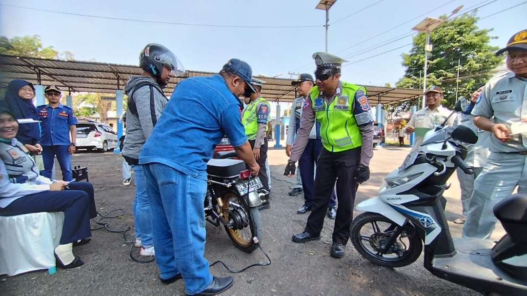 Petugas mengecek emisi kendaran roda dua dalam razia gabungan (Foto: Muh Hujaini/Ngopibareng.id)