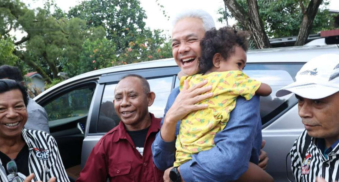 Ganjar Pranowo disambut antusias warga Sorong saat tiba di Bandara Domine Eduard Osok, Kota Sorong. Ganjar juga sempat menggendong anak warga yang menyambutnya dengan gegap gempita. (Foto: Tim Media Ganjar Pranowo)