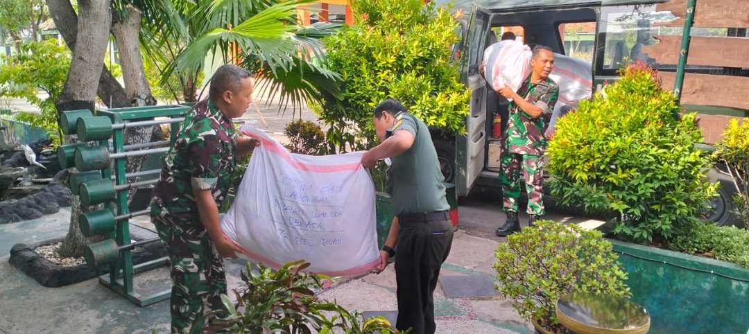 Anggota Kodim. 0812 Lamongan sedang mengangkut bantuan untuk Palestina ke dalam mobil. (Foto: Istimewa)