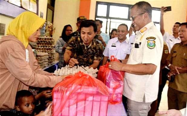 Pj Bupati Bondowoso Bambang Soekwanto memberikan bantuan telur dan susu pada anak balita usia di bawah 2 tahun yang mengalami stunting. (Foto: Guido Saphan/Ngopibareng.id)